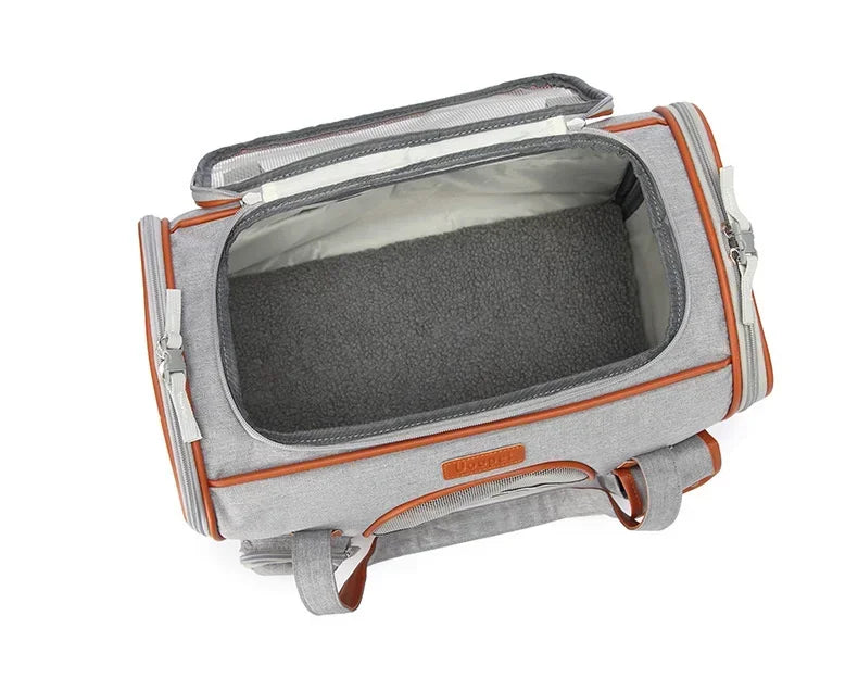 Gray pet carrier with orange accents on a white background