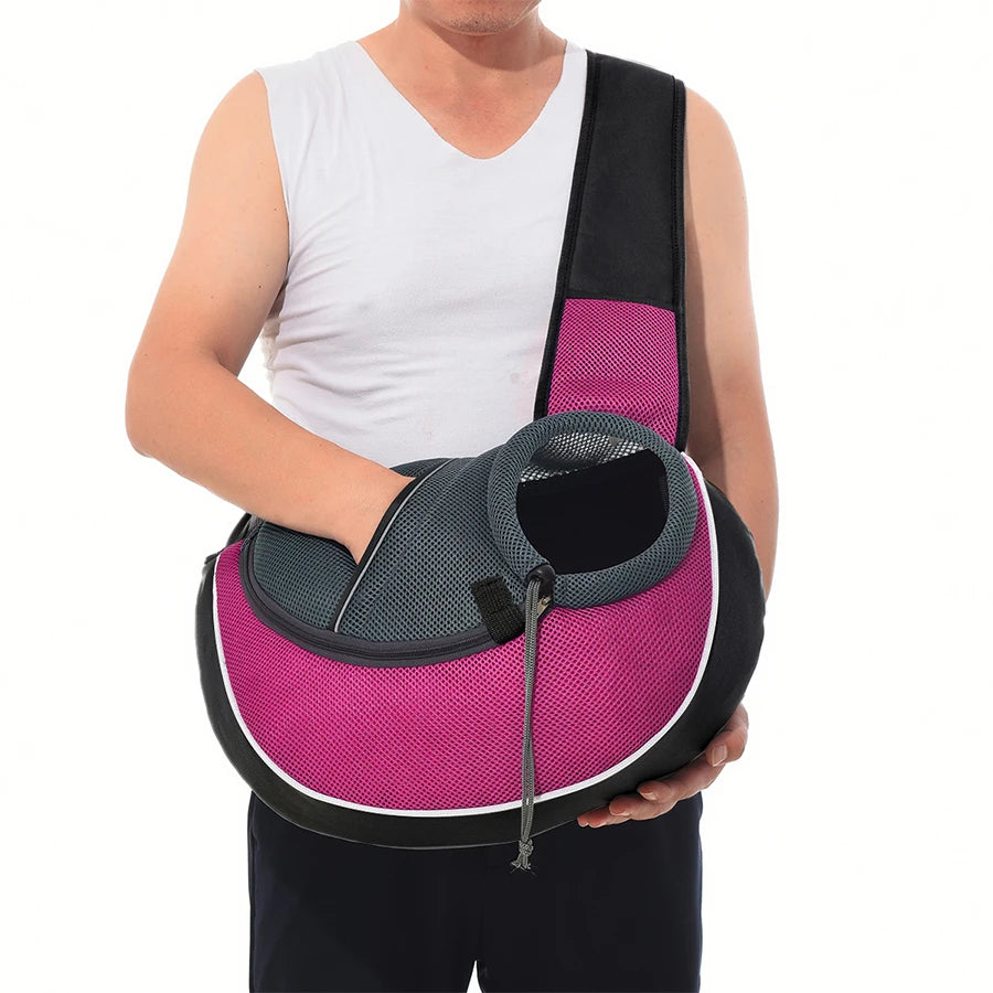 Person holding a pink and gray pet carrier on a white background