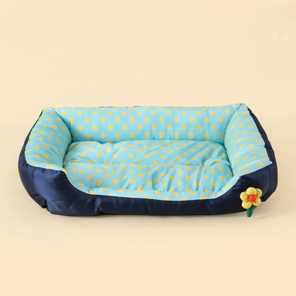Pet bed with blue and yellow polka dot design on a beige background